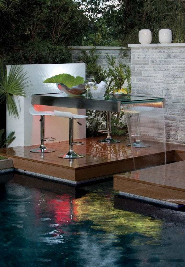 My gut feeling on this set up is that it is there for decoration.  The water feature would probably be too noisy to hold a conversation and after a few wines, it could be treacherous to get to.  What do you think?