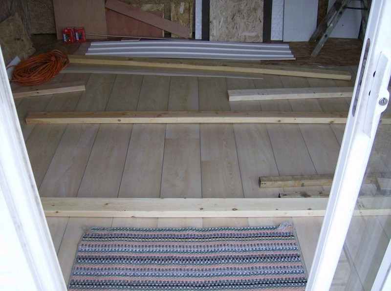 How To Build A DIY Pallet Shed - Putting linoleum on the floor