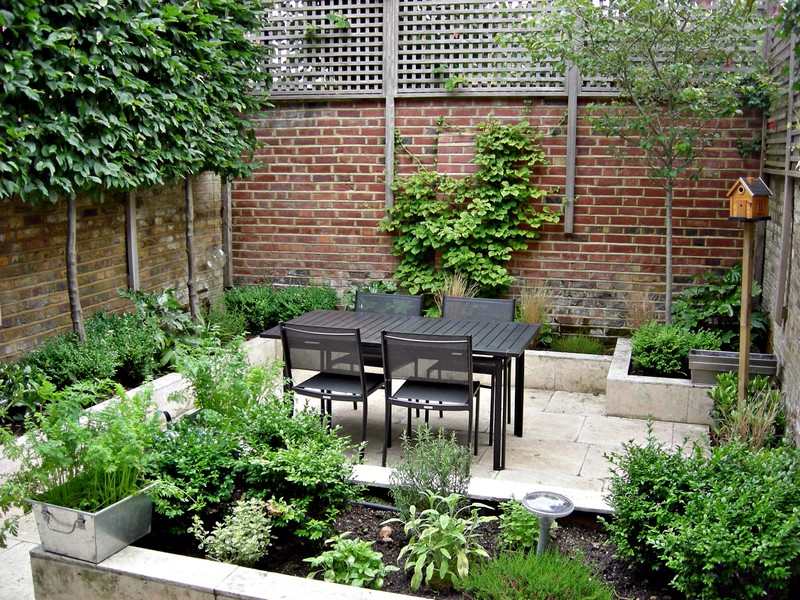 Courtyard with dining area and raised bed planters.
