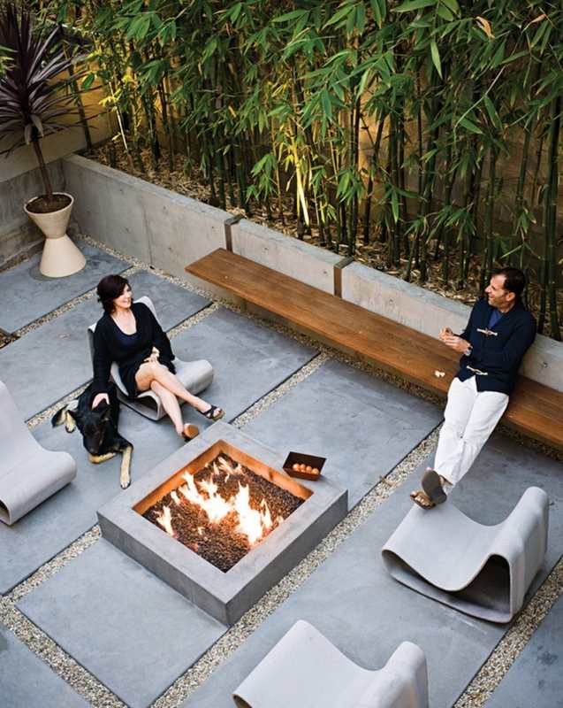 Courtyard with custom made fire pit, concrete pavers, and bench.