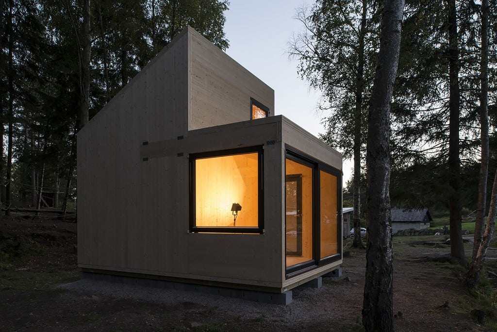 The structure has no electricity; indoor heat comes from a wood-burning stove.