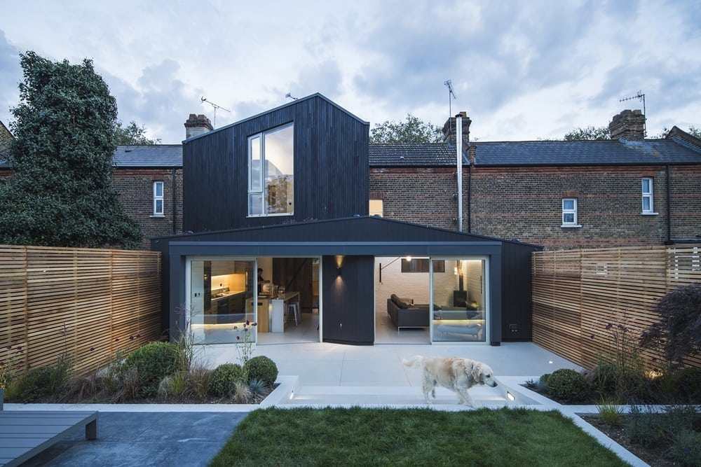 Blackened timber contrasts with the Victorian brickwork of the existing structure.