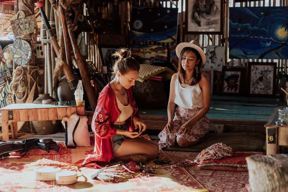 An image of two women sitting in a Boho style living space.