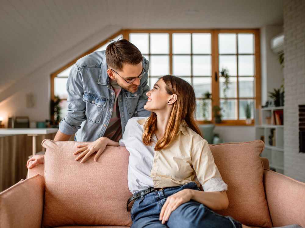 An image of a Gen Z couple on a couch. 