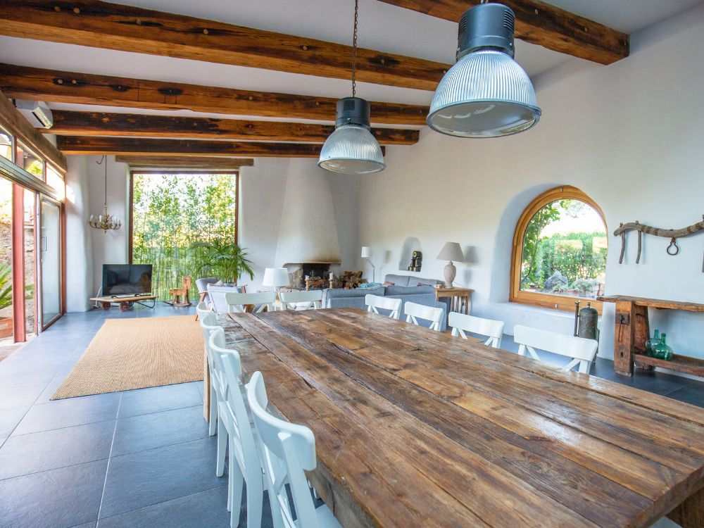 An image of a dining and living room with a farmhouse decor. 
