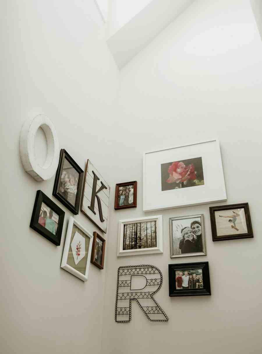 A display combining photos, art prints, and other wall decors.
