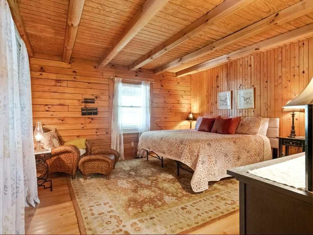 An image of a wooden paneled bedroom with vintage furniture. 