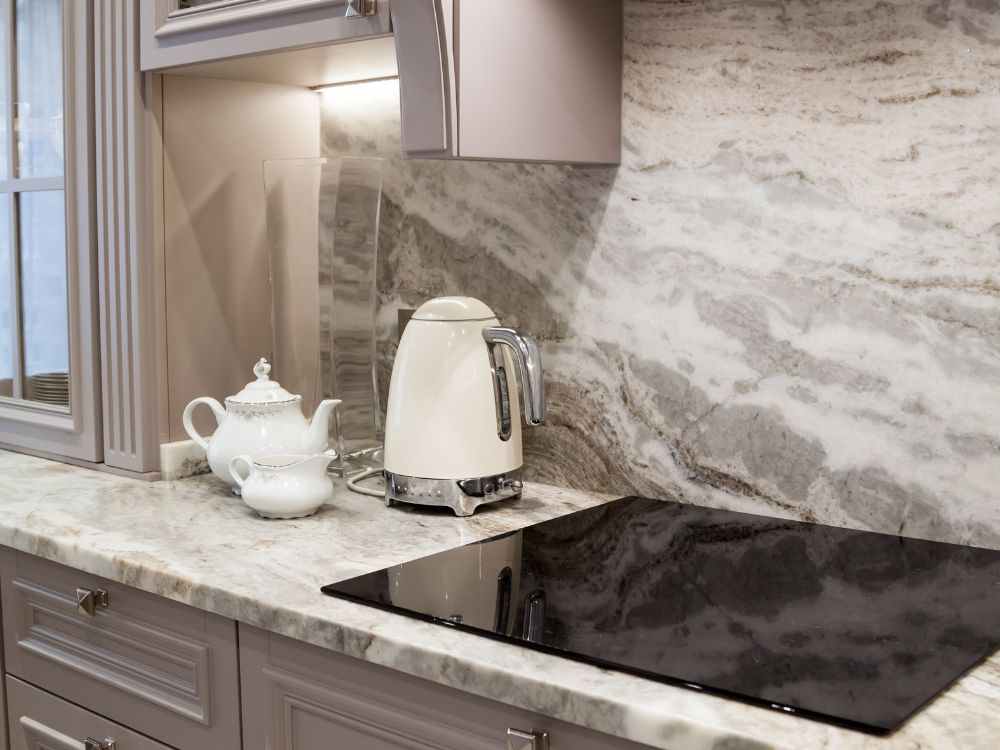 an image of an induction oven and other appliances on top of soapstone countertops.