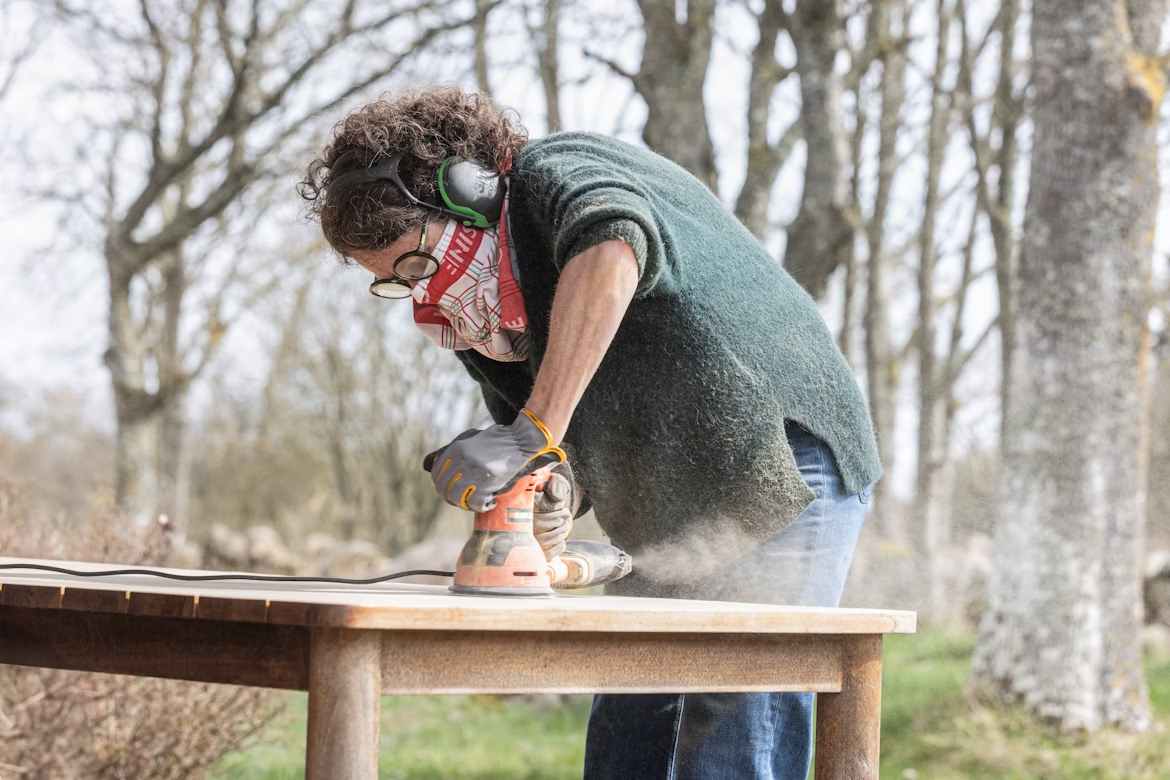 An image of a person using a sander. 