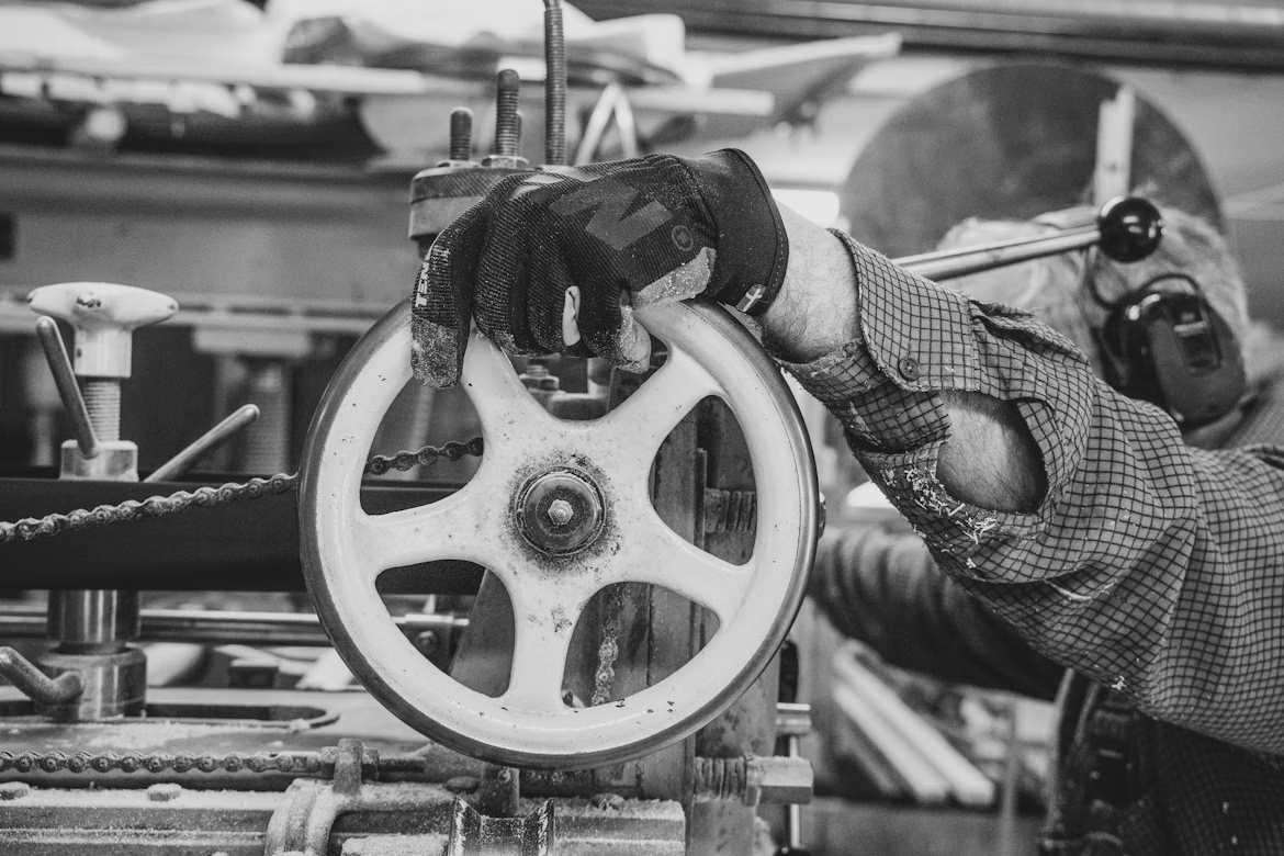 An image of a person operating a machine while wearing gloves.