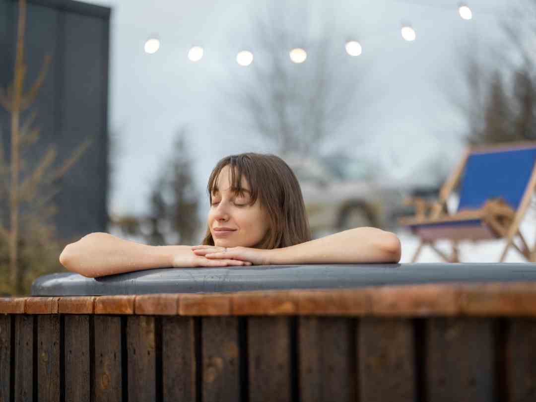 A woman enjoying time in her hot tub.