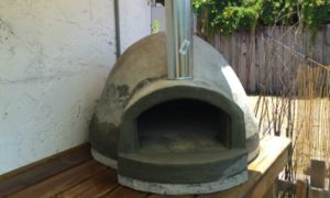 Wood-fired pizza oven built using exercise ball