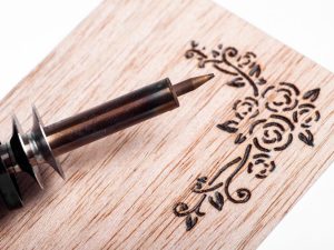 an image of a pyrography art pen and wooden board.