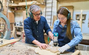 Am image of two people creating cheap DIY gifts woodworking projects.
