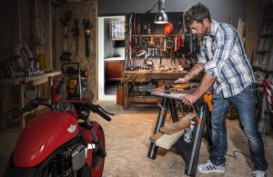 An image of a person using foldable work table for their project.