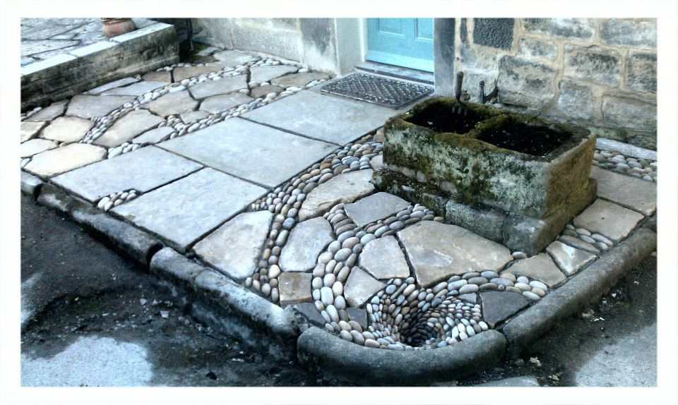 'The patio that flows down the drain' Yorkshire stone flagstones, cobbles finishing with a pebble mosaic whirlpool working drain