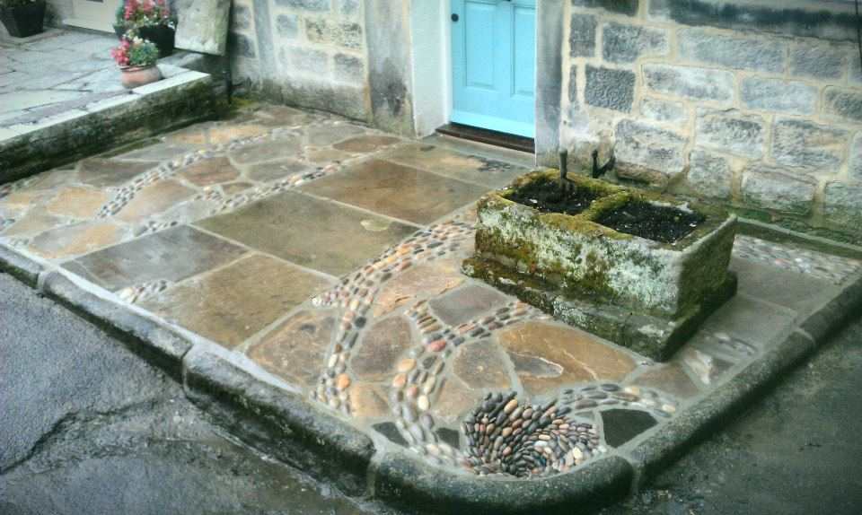 'The patio that flows down the drain' Yorkshire stone flagstones, cobbles finishing with a pebble mosaic whirlpool working drain