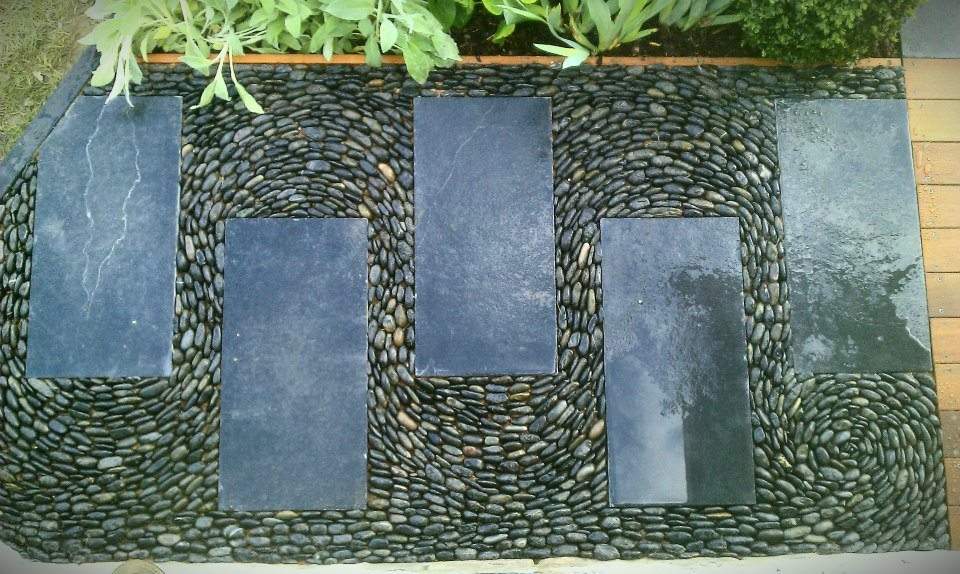 Swirly pebble mosaic path, black limestone paving and polished black pebbles (gold award winning show garden at the 2012 Harrogate Spring flower show) — at Harrogate Flower Show.