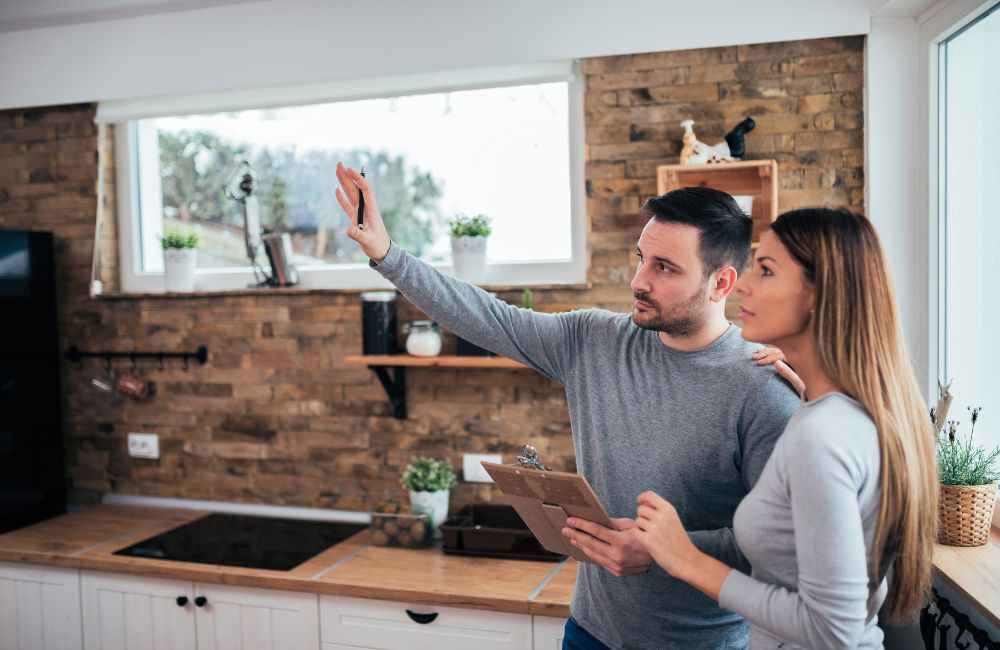 An image of a couple planning their rental property kitchen renovation.